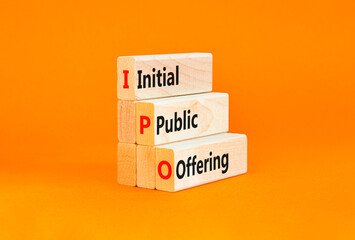 Naklejka premium IPO initial public offering symbol. Concept words IPO initial public offering on beautiful wooden blocks. Beautiful orange background. Business IPO initial public offering concept. Copy space.