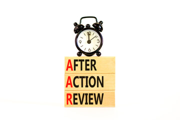 AAR After action review symbol. Concept words AAR After action review on beautiful wooden blocks. Alarm clock. Beautiful white background. Business AAR after action review concept. Copy space.