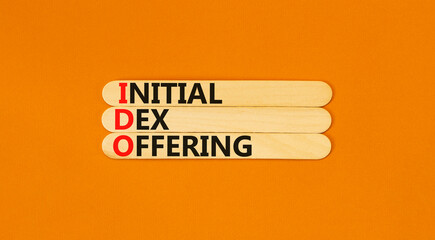 IDO initial DEX offering symbol. Concept words IDO initial DEX offering on beautiful wooden stick. Beautiful orange background. Business IDO initial DEX offering concept. Copy space.