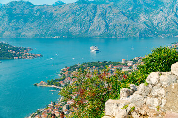 Spectacular View of Kotor Bay: Mountains, Cruise Ship, and Azure Waters