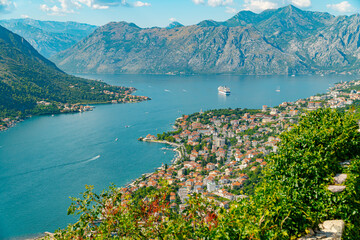 Spectacular View of Kotor Bay: Mountains, Cruise Ship, and Azure Waters