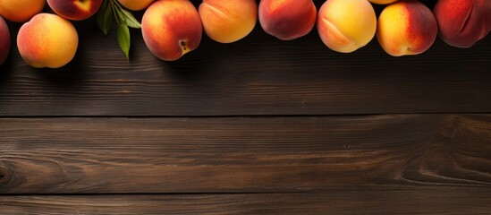 A bunch of peaches arranged on a wooden surface seen from above with space for text A display of healthy vegan fruits. Copyspace image - Powered by Adobe