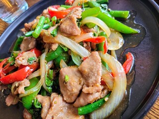 Stir-Fried Pork and Vegetables on Dark Plate, Eye-Level View