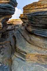 The narrow volcanic gorges and fissures of The Cracks ( Las Grietas ) . The slope of the Montana Blanca volcano. Lanzarote, Canary Islands, Spain