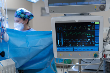 Monitor screen with vital sign and ECG data of patient during surgery inside operating room in hospital.Monitor people under anesthesia. showing patient heart rate and blood pressure