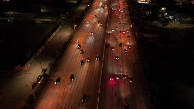 Aerial drone reveal shot of Miami i95 city traffic at night. Cars driving at night in Downtown Miami I 95 Highway 
