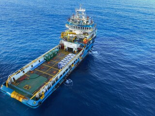 Supply boat transfer cargo to oil and gas industry and moving cargo. Boat waiting transfer cargo and passenger between oil and gas platform for hard work in offshore