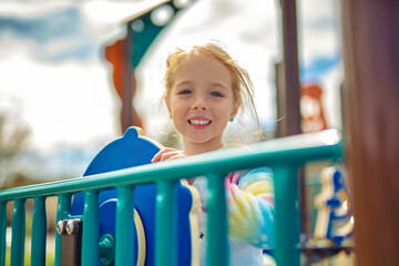 Child girl, Playing on Playground in spring time