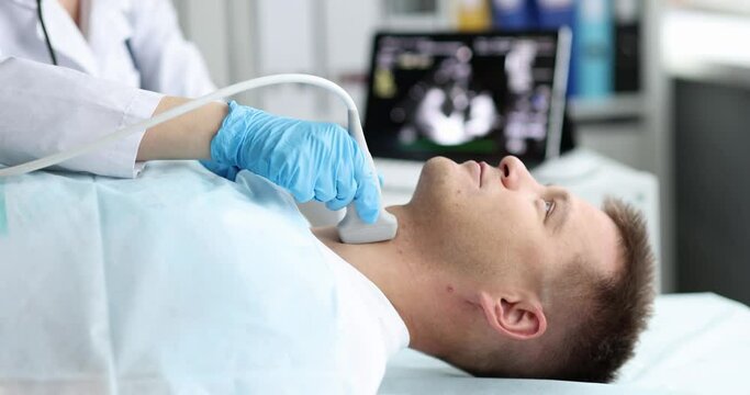 Man examine thyroid gland with ultrasound probe in medical office. Thyroid disease in man concept