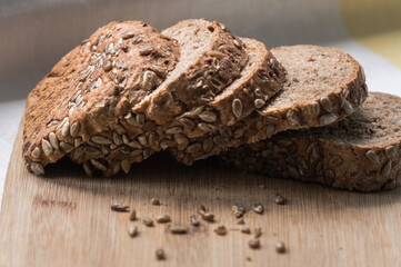 Sliced rye bread with sunflower seeds on a cutting board