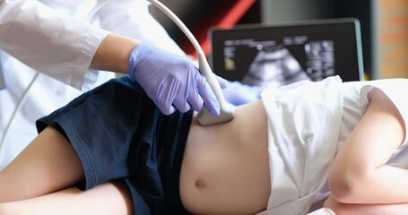 Ultrasound doctor make ultrasound of abdomen and kidneys of child. Girl is examined in office of children hospital
