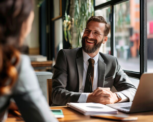 portrait of a businessman smiling at coffee shop table