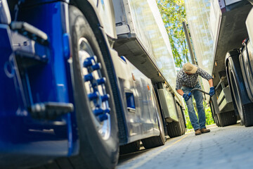 Truck Driver Examining Cargo Trailer