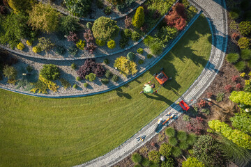 Aerial View of Landscaper Aerating Clients Lawn