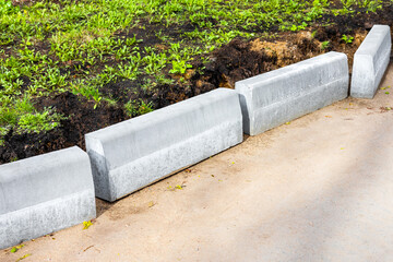 laying curb stones on a sidewalk in the city.