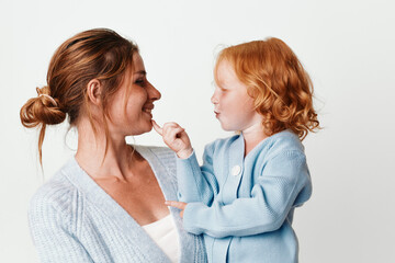 Mother and child with red hair looking at camera in a loving embrace in a warm family moment