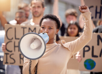 Woman, protest and megaphone with group for climate change support, global warming or crowd. Female...