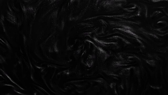 Liquid dark motion organic background. Shine glitter fluid metallic black color paint. Texture abstract acrylic cloud swirling underwater.	