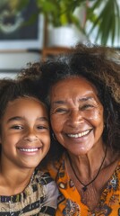 Fototapeta premium A joyful moment captured between a smiling woman and a young girl both radiating happiness set against a blurred indoor background with a hint of greenery.