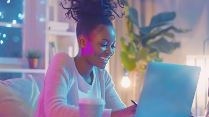 Business And Education Concept Smiling young black woman sitting at desk working on laptop writing...