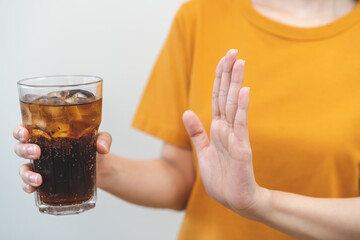 Diet, Dieting. Attractive asian young woman, girl push out cold cola, refuse carbonated soft drink...