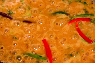 Adding boiling dal lentil into bagar tadka with deep fry tomato onion garlic cumin red dry chilli...