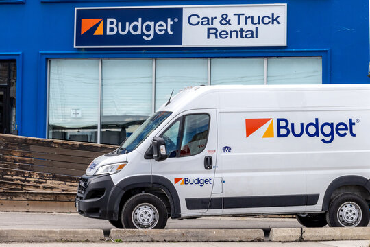 Toronto, Canada, May 10, 2024; A Budget Car and Truck Rental location with a rental van under the Budget sign with the orange logo behind.