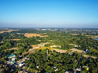 top aerial still picture of a green village with farmland in asia