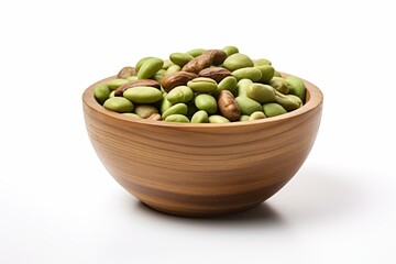 Wooden bowl overflowing with green lima beans and pinto beans on a white background