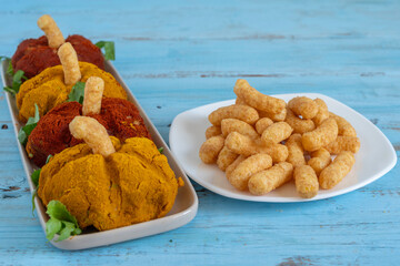 Pumpkin shaped appetizer made with creamy vegetables served with peanut corn sticks and lettuce leaves for Halloween, Harvest, Thanksgiving Day.