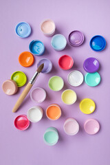 Pastel colors gouache in jars on table top view. Creative hobby painting concept.