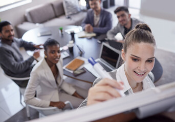 Fototapeta premium Woman, smile and writing on board in boardroom for presentation with strategy and planning for project. Office, people and happy for teamwork or collaboration and training for business growth
