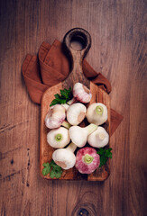 Fresh young garlic, white and purple color, on a wooden table, no people,
