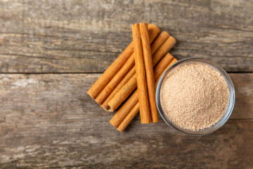 Cinnamon sugar on a texture background. Homemade cinnamon sugar in a bowl on background. Brown sugar. Spice mixture for drinks and baking. Place for text. Copy space.