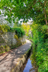 The Water Lanes, pedestrian path along a small canal in St Peter POrt, Guernsey, Channel Islands