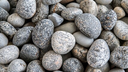  A stack of gray and white rocks atop brown and white ones..Or:..Gray and white rocks stacked upon brown and white ones