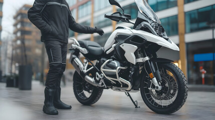 Motorcyclist standing next to adventure bike in city
