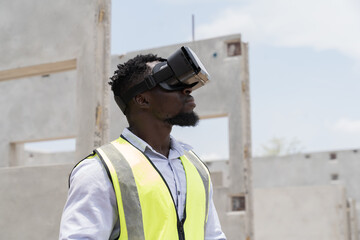 African American male construction engineer wearing virtual reality headset inspecting quality of structural at construction site. Male construction engineer working with VR headset at site work - Powered by Adobe