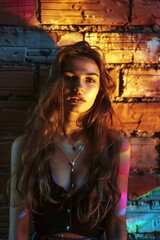 Fototapeta premium Beautiful modern girl near brick wall and sun rays