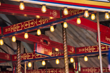 Ornate Carousel Detail with Glowing Bulbs and Diagonal Beams