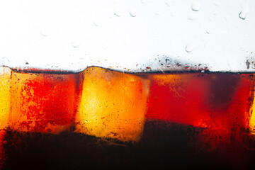 Macro cola drink close-up,macro soft drink texture,Soft drink glass with ice splash on dark...