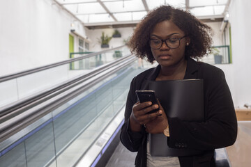 serious focused busy professional woman with smartphone reading email