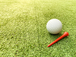 Golf ball placed on artificial grass.