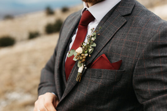 Close-up photo of a man in suite wearing red tie