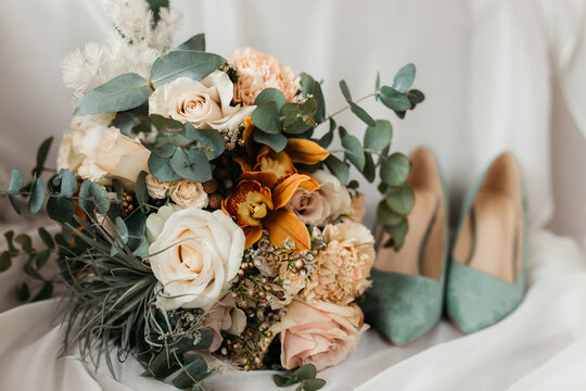 Wedding brides shoes and bouquet