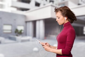 pretty young woman in city street hold smart phone