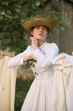 village woman hangs clothes in nature
