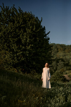  young woman in the garden near the trees