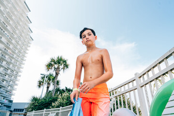 Teenager drying off after swimming in the pool. 
