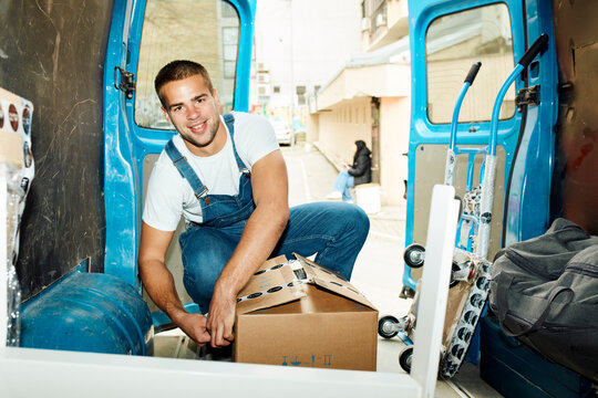 Portrait of a smiling worker in a van